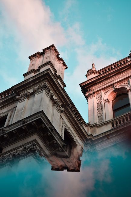 A beautiful low angle shot of historic architecture in London with a vibrant blue sky.