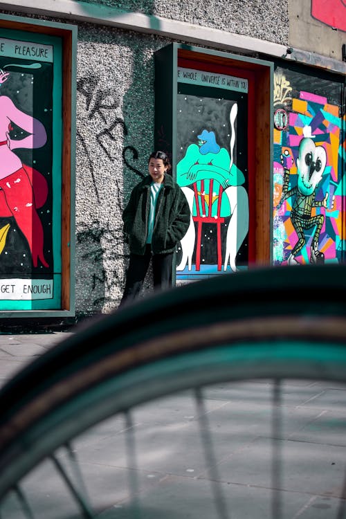 Man Wearing Jacket Standing Near Wall