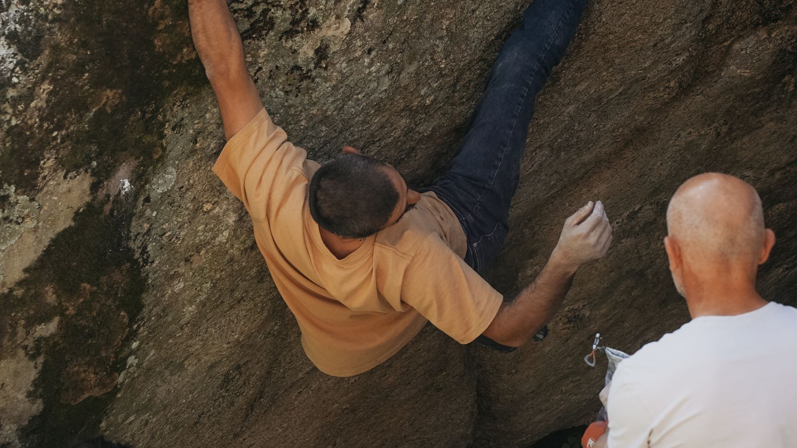 A climber working a bouldering problem