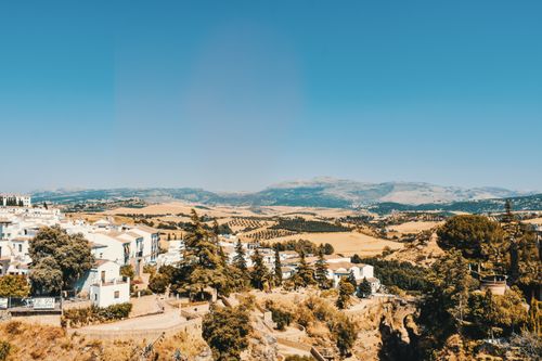 Free Picturesque view of Spanish countryside with white houses and rolling hills under a clear blue sky. Stock Photo