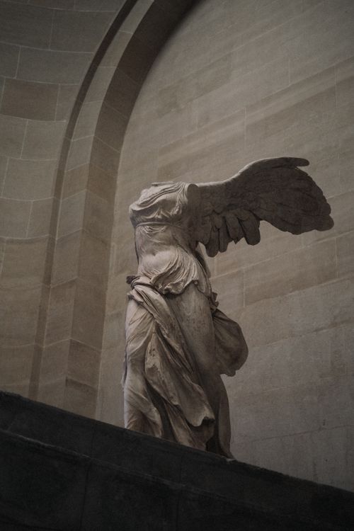 Free Intricate sculpture of the Winged Victory of Samothrace inside a museum, showcasing classical art. Stock Photo