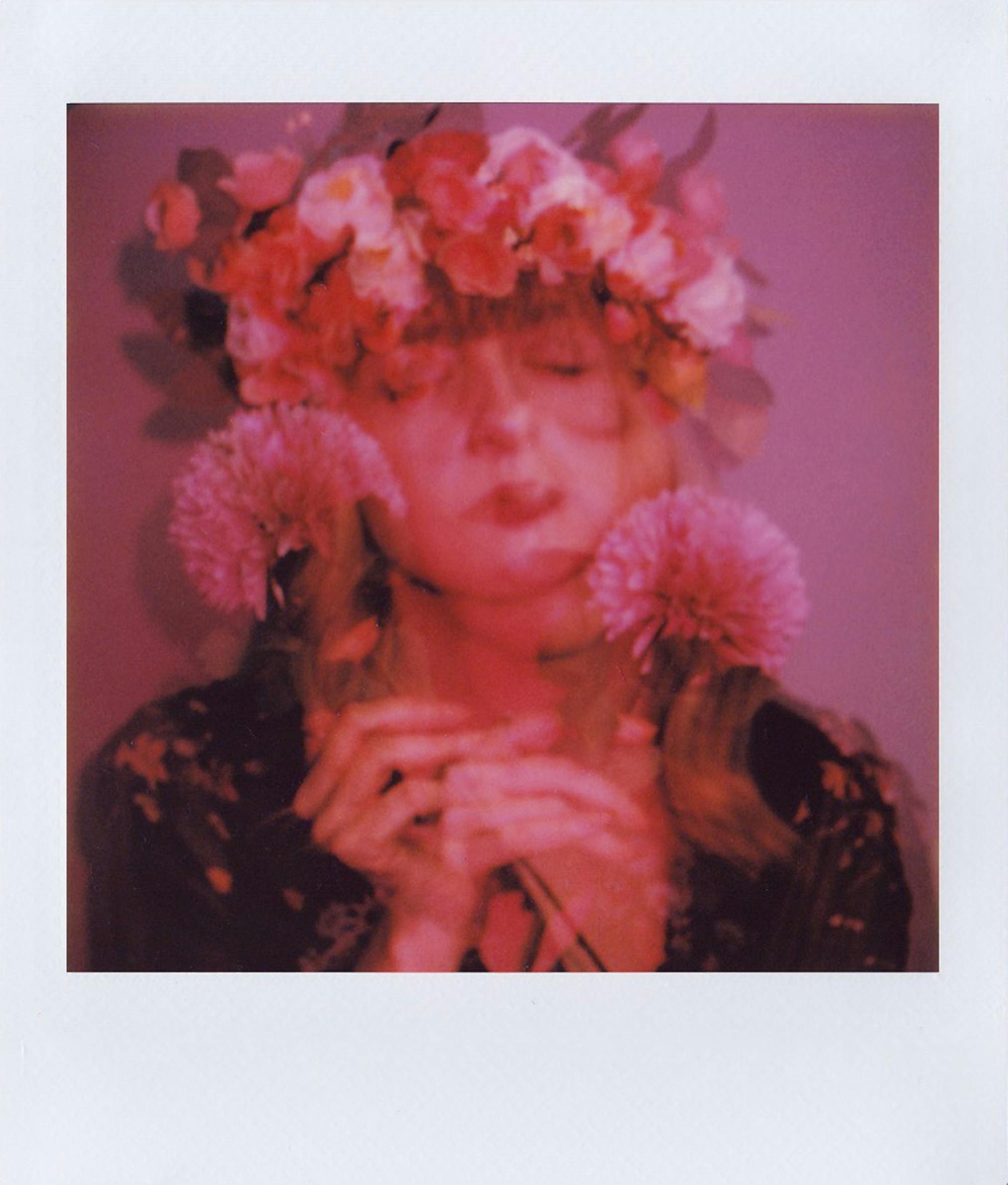 A surreal, dreamy portrait of a woman with a flower crown and blurred artistic effect.