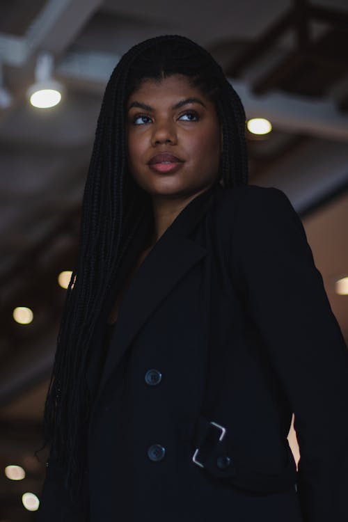 Free Photo of a Young Woman with Braided Hair Wearing a Black Jacket  Stock Photo