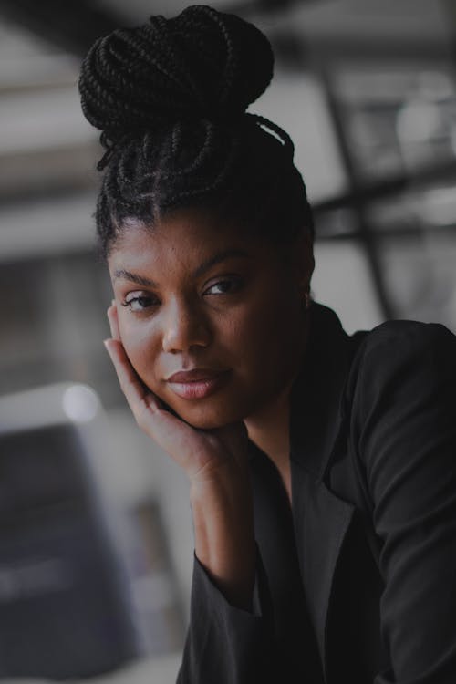 Free Photo of a Young Woman with Braided Hair Wearing a Black Blazer Jacket  Stock Photo