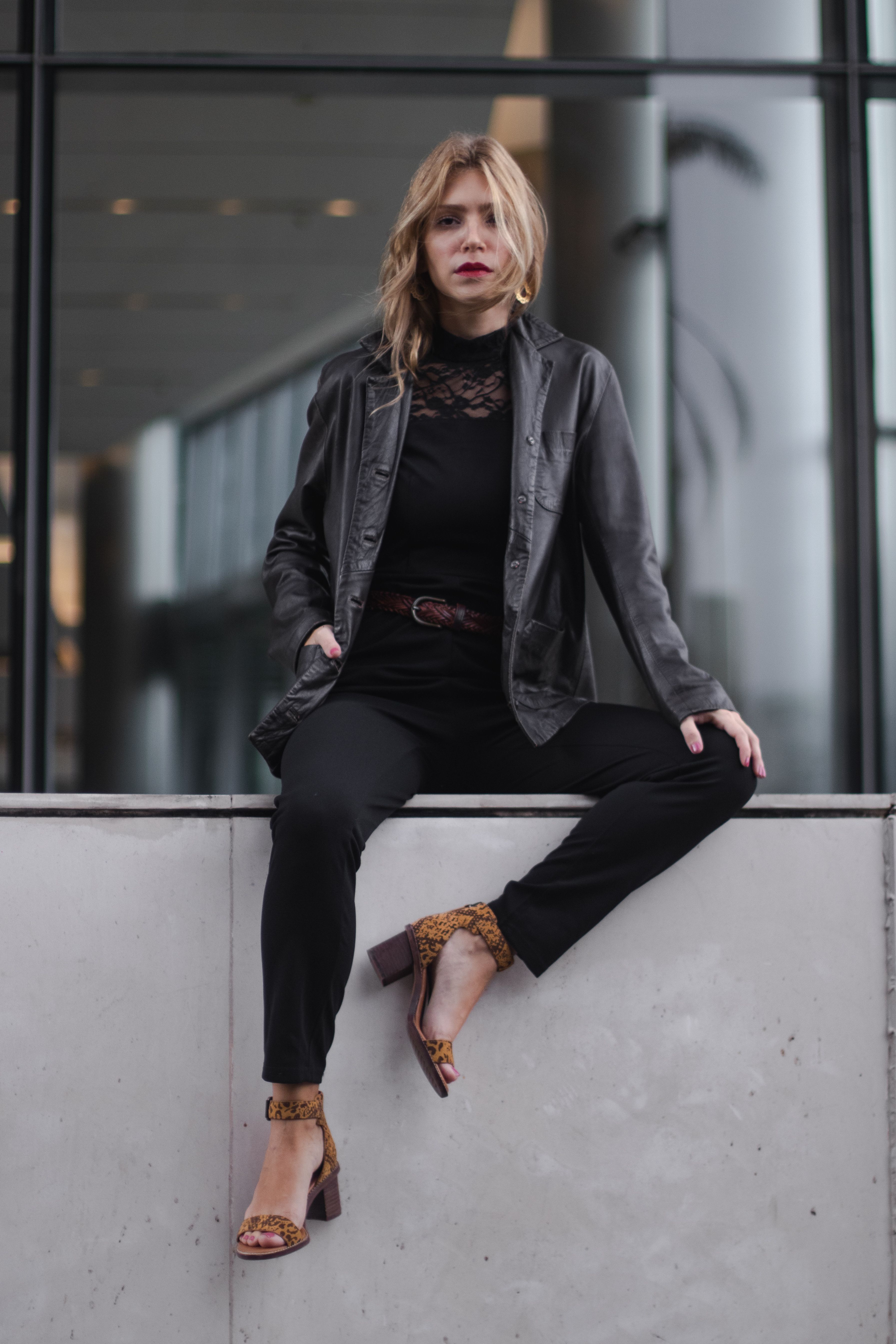 Sitting on Wall Woman in Black Leather Jacket · Free Stock Photo