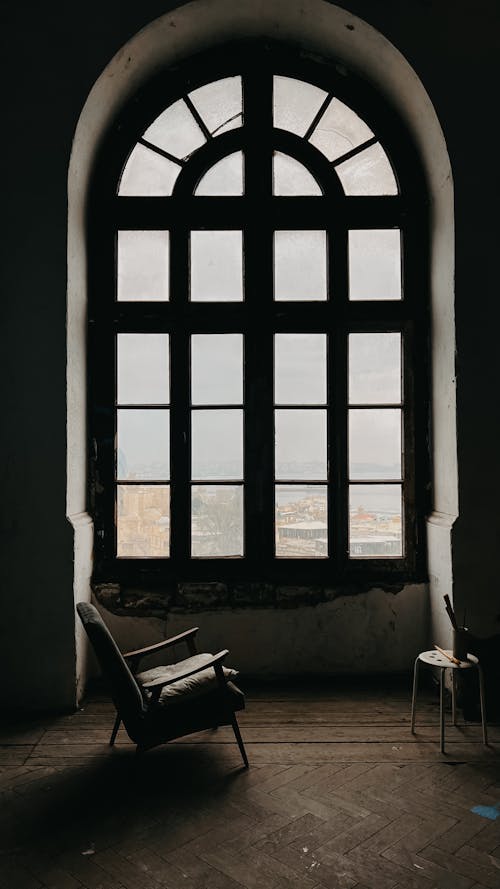 A chair and window in an empty room