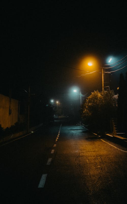A street with a street light at night