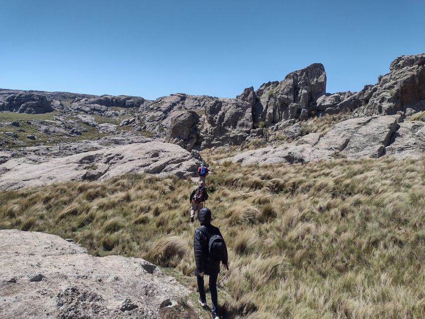 South Georgia Spring Photo Tour: Capture Nature's Wonders - Group of hikers walking on a rocky mountain trail on a sunny day.