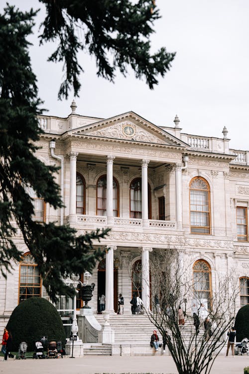 A large mansion with a white roof and columns