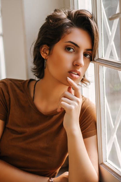 Close-up Photo of Woman Leaning on Window