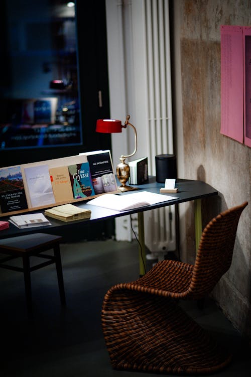 Free A desk with a lamp and a chair in a room Stock Photo