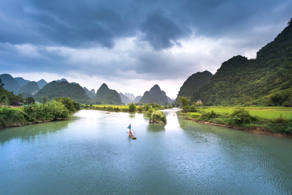 Free Man On Boat In Lake Stock Photo