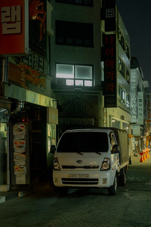 A white van parked on a street at night