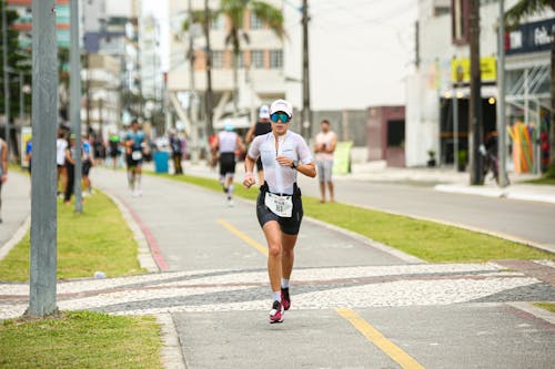A woman running on a sidewalk in a city