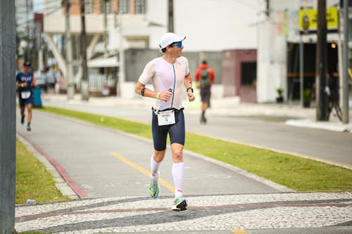 A man in a running outfit is running down the street