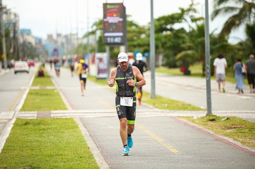 A man running down a road in a triathlon