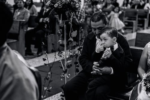 Free A man and a boy are sitting in a church Stock Photo