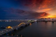 日落时分，天空充满活力，城市天际线的壮丽景色与照亮的大桥交相辉映