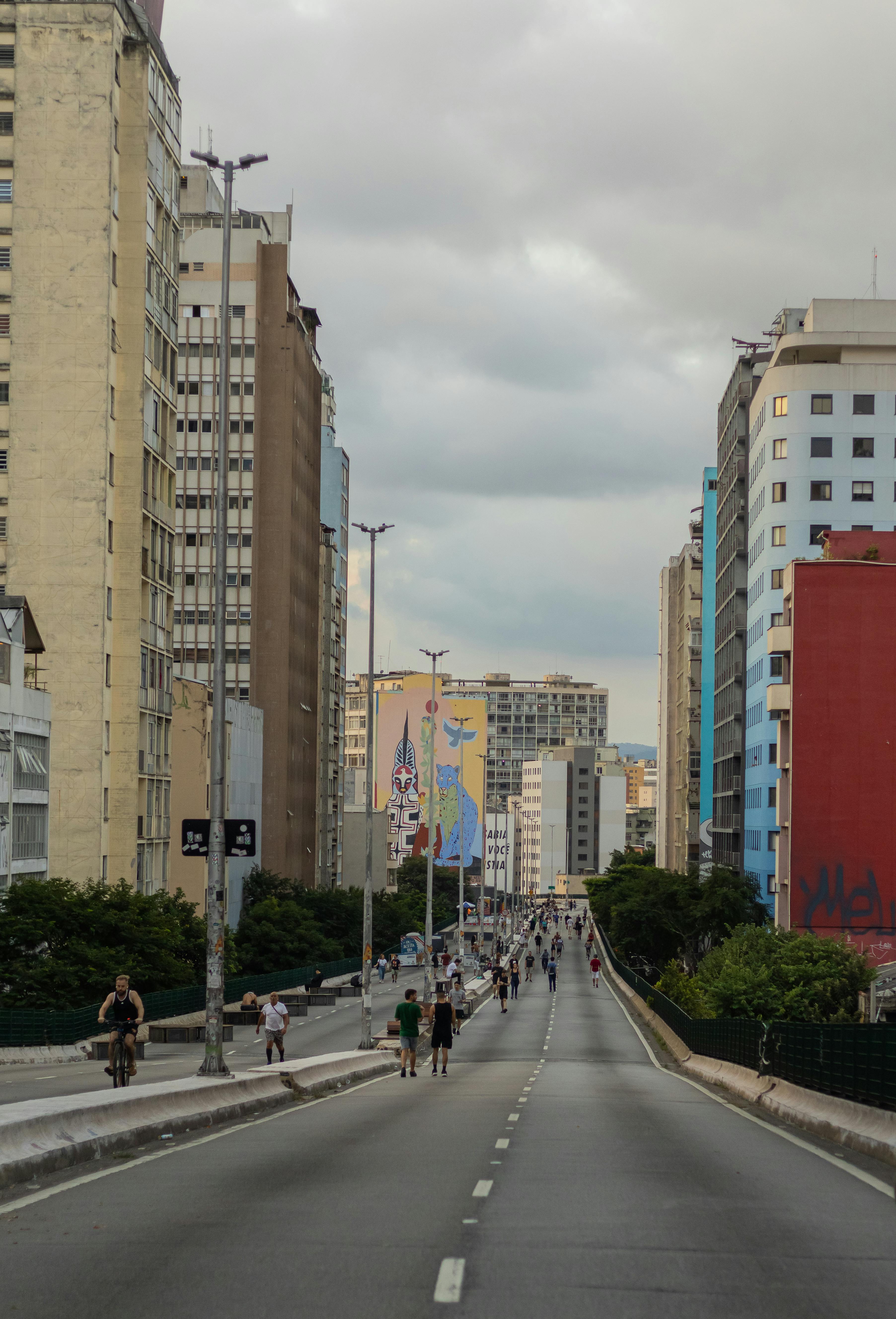 a city street with many buildings and people walking