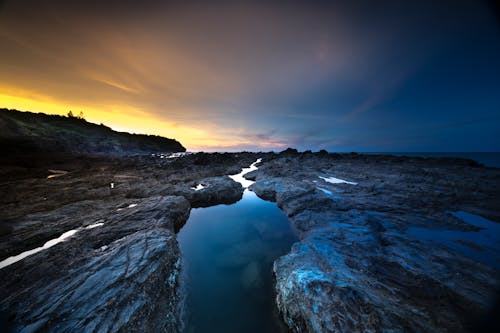 Free Body of Water With Rock Formation Stock Photo