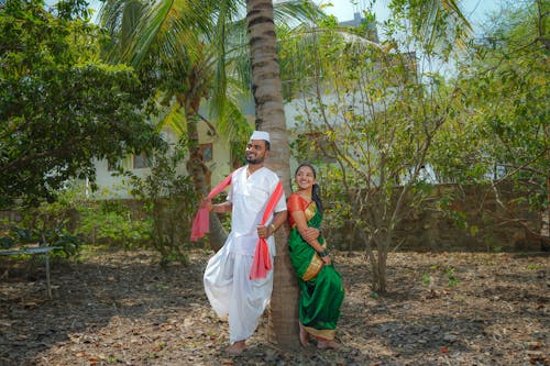 INDIAN COUPLE IN FARM IN TRADITIONAL ATTIRE 