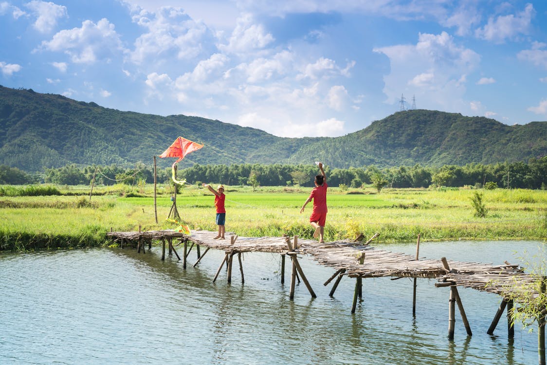 গল্পঃ ঘুড়ি 2 Two People Running On Bridge Over Body Of Water