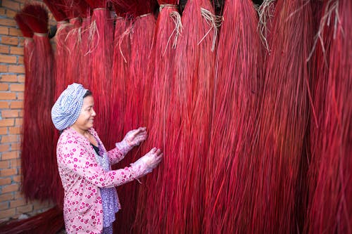 Woman Touching Red Broom