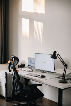 A clean and organized home office setup with a computer, desk, and ergonomic chair.