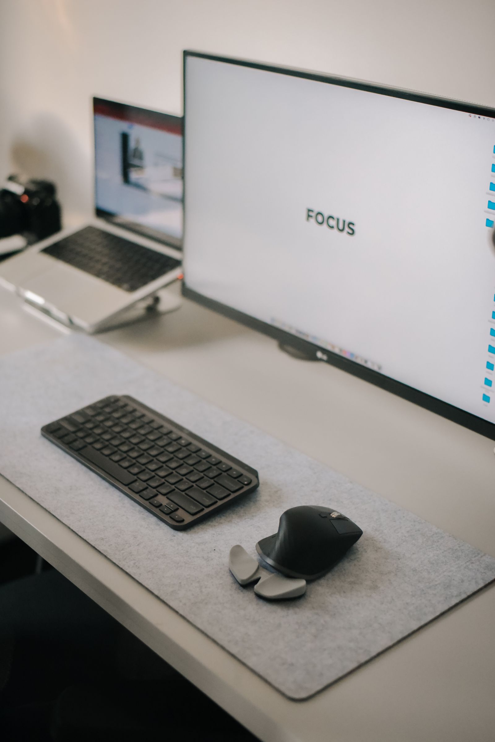 Clean dual-monitor workstation with keyboard, mouse and organized technology