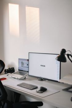 A clean and organized home office setup featuring dual monitors and a modern workspace.