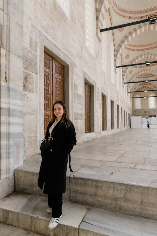 A woman standing in front of a building