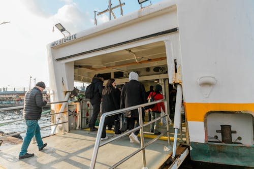 People boarding a ferry boat with luggage