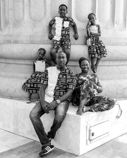 Free  Family Sitting on the Base of a Huge Column Stock Photo