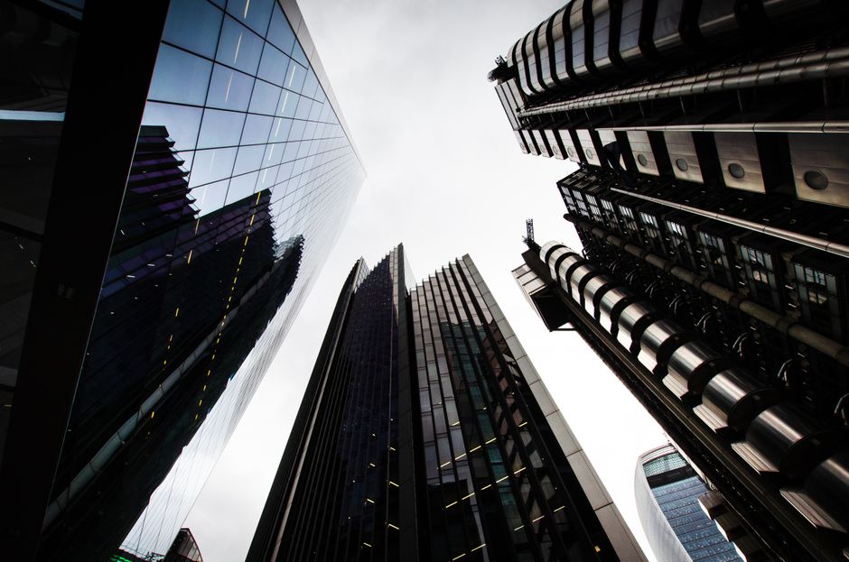 Low angle view of modern skyscrapers in London's financial district, featuring innovative architecture and reflective glass.