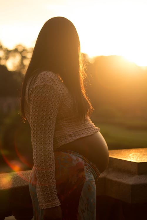 Pregnant Woman Looking at Sunset