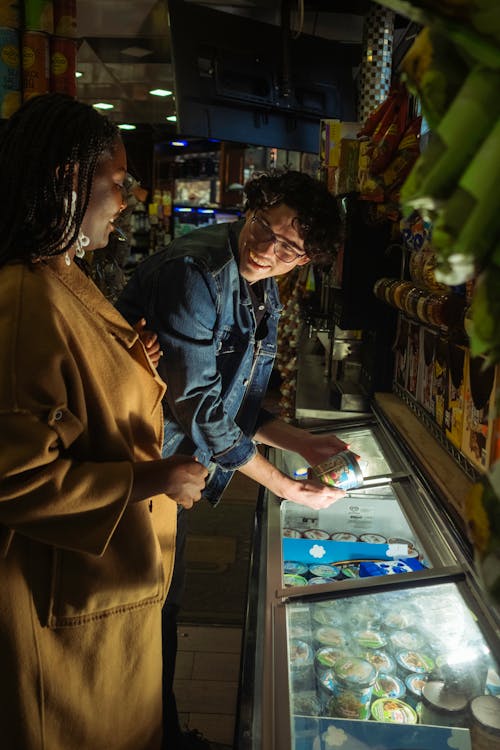 Two people looking at food in a store