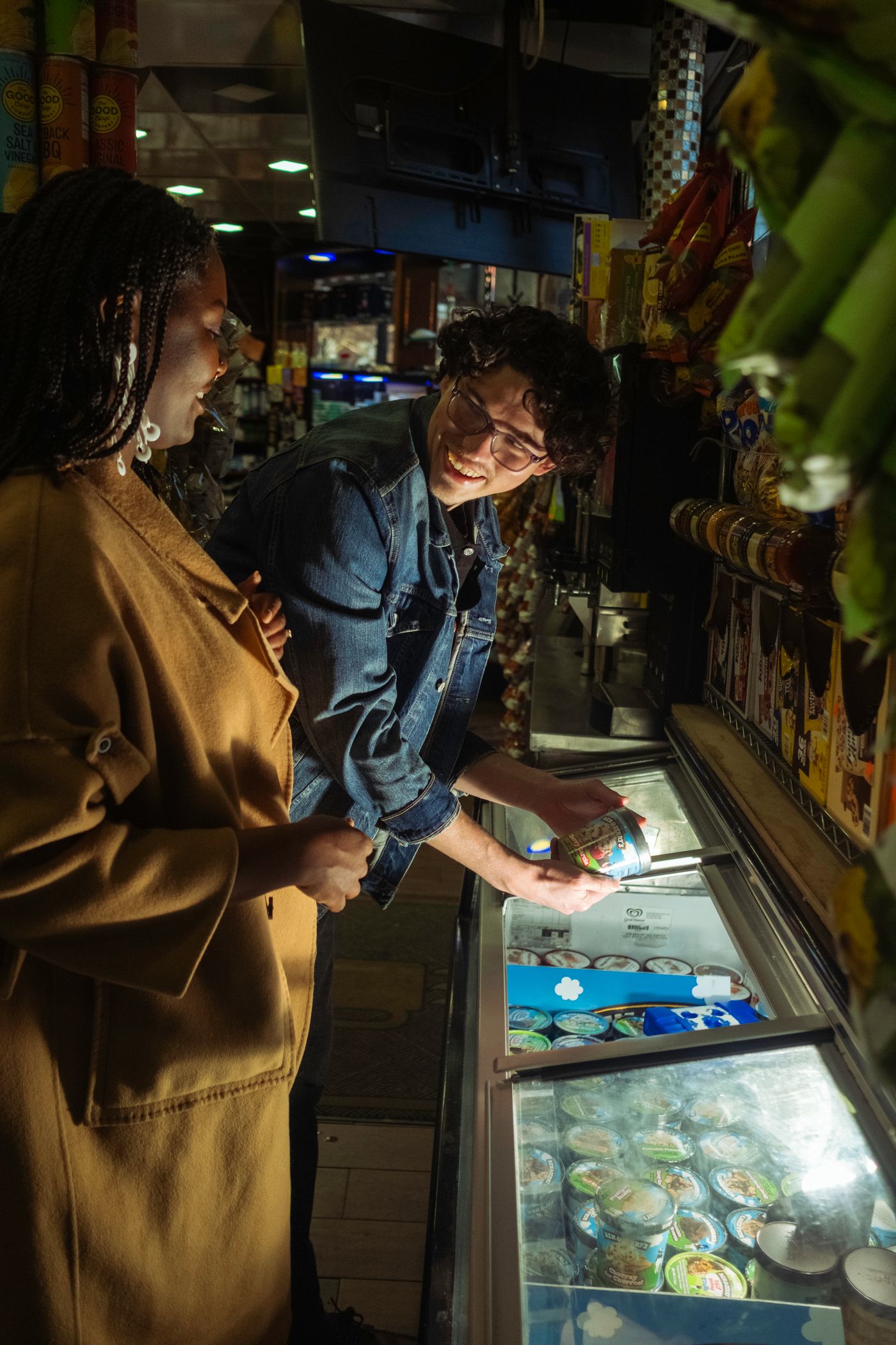 Shoppers choosing ice cream from a retail freezer where temperature history affects quality