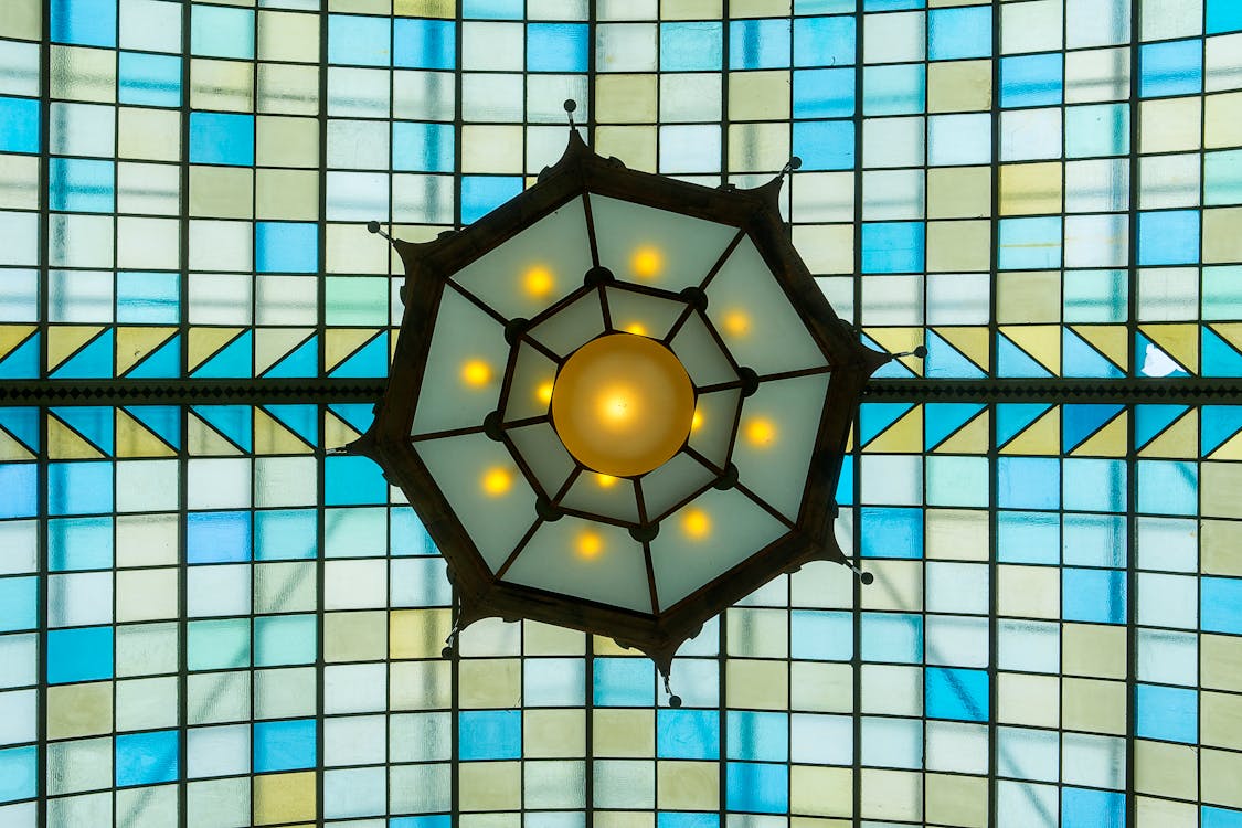 A stained glass ceiling with a blue and yellow star