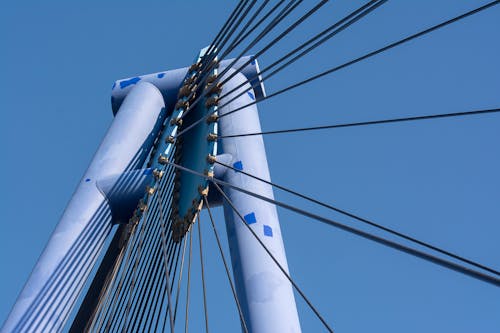 A close up of a blue and white cable bridge