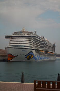AIDAperla cruise ship moored at an urban dock, perfect for travel enthusiasts.