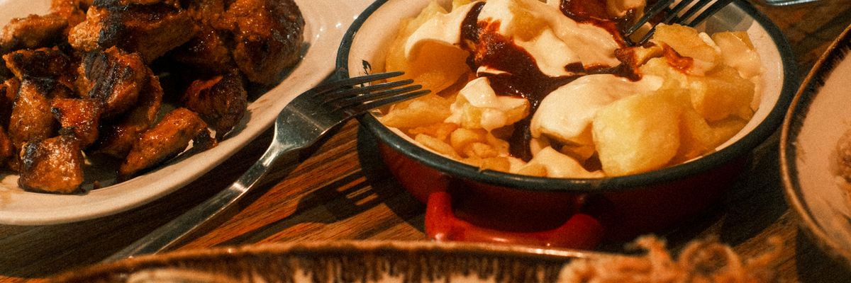 Spaanse tapas — patatas bravas, pincho moruno, gefrituurde inktvis