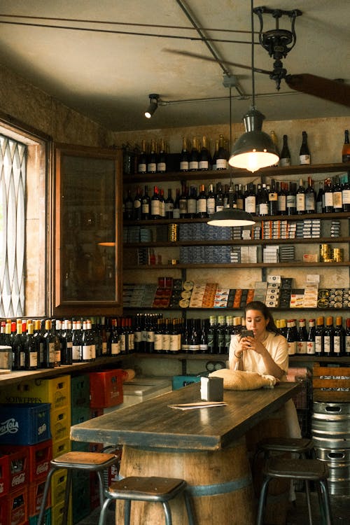 A man sitting at a bar in a wine shop