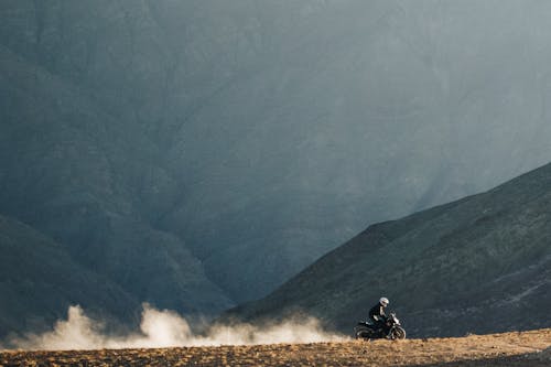 A person riding a motorcycle on a dirt road
