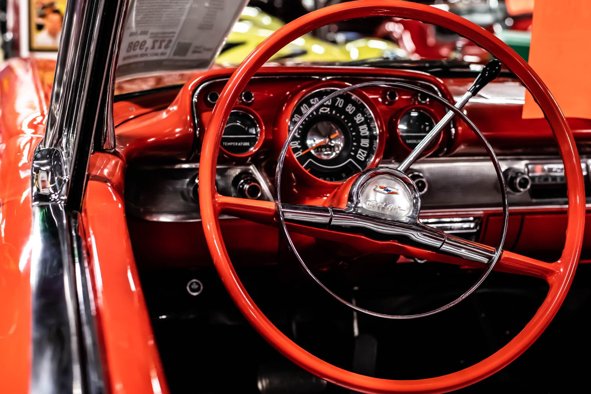 Detailed view of a vintage Chevrolet dashboard with red steering wheel.