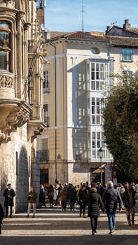 Captivating street view of Burgos, Spain, with pedestrians enjoying a sunny day.
