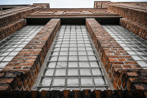 Free Low angle view of brick building facade with glass blocks and symmetry in Osnabrück, Germany. Stock Photo