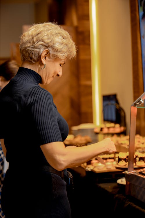 A woman in a black shirt is serving food
