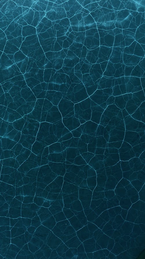 A blue water surface with cracks and cracks