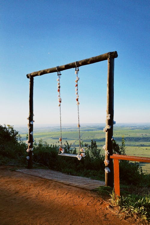 A swing on a hill overlooking the ocean