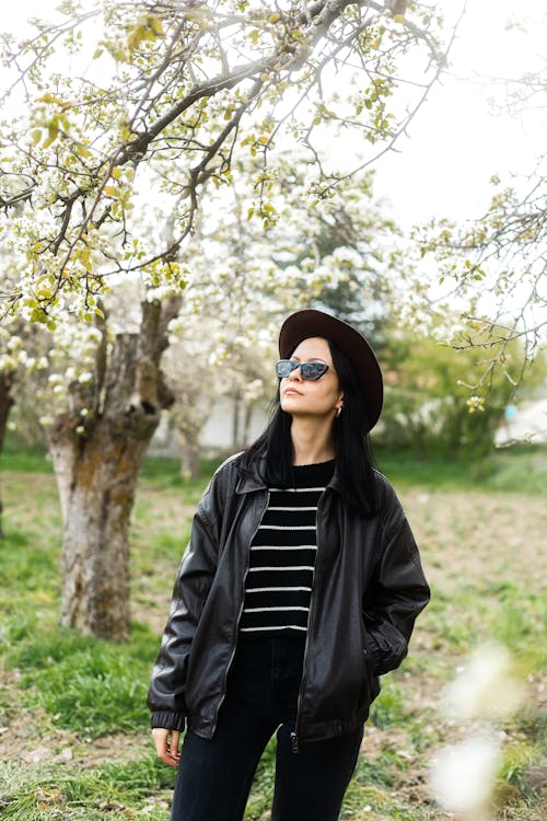 Woman in Hat and Jacket in Orchard